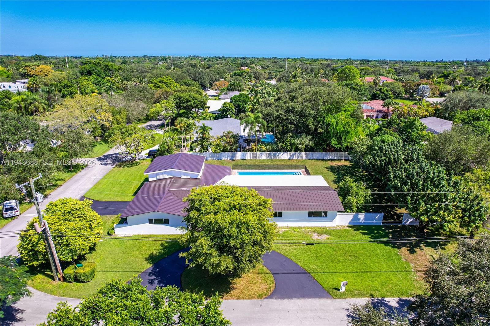 12525 Southwest 68th Court Pinecrest, FL 33156 - Photo 44 of 46 an aerial view of residential houses with outdoor space and trees