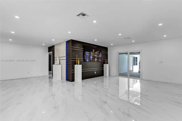 a view of kitchen with refrigerator and window