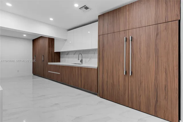 a kitchen with stainless steel appliances a refrigerator and a sink