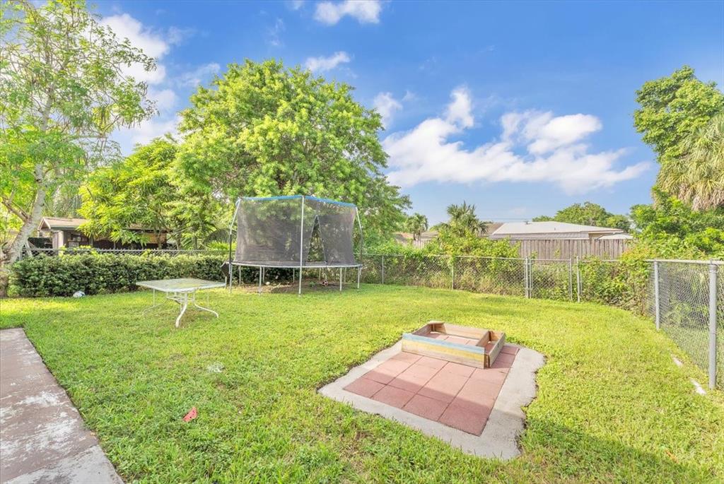 6621 Southwest 19th Street Pompano Beach, FL 33068 - Photo 15 of 16 a backyard of a house with table and chairs