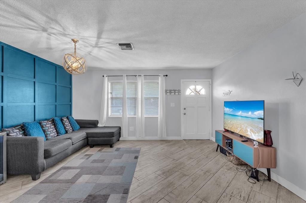 6621 Southwest 19th Street Pompano Beach, FL 33068 - Photo 3 of 16 a living room with furniture and a flat screen tv
