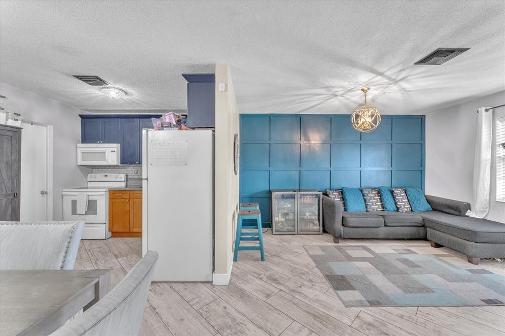 6621 Southwest 19th Street Pompano Beach, FL 33068 - Photo 4 of 16 a living room with furniture and kitchen view