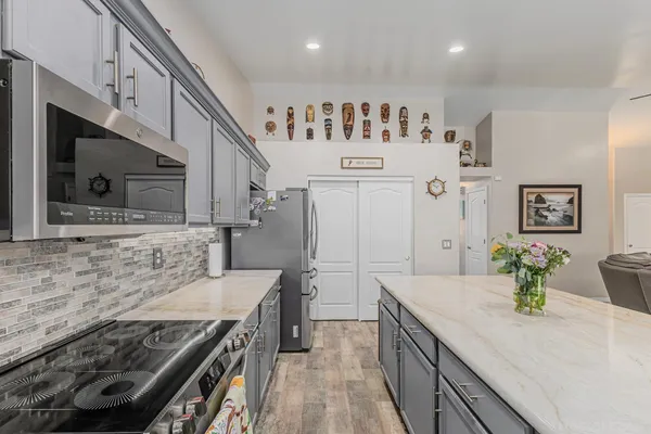 a kitchen with stainless steel appliances granite countertop a stove and a sink