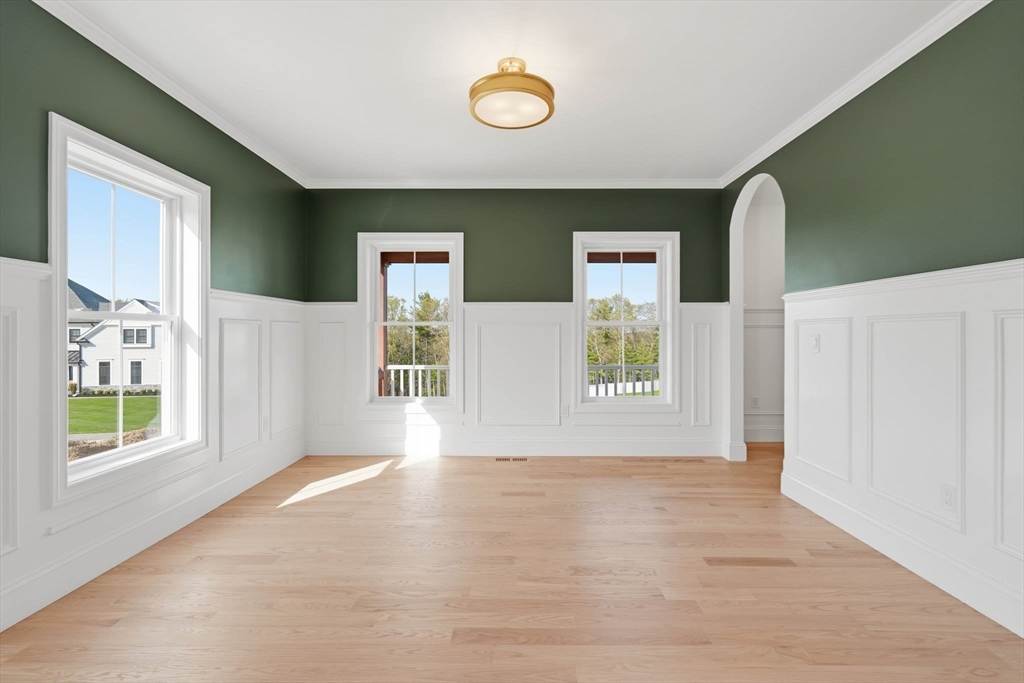 16 Couture Way Middleton, MA 01949 - Photo 15 of 36 a view of an empty room with window and wooden floor