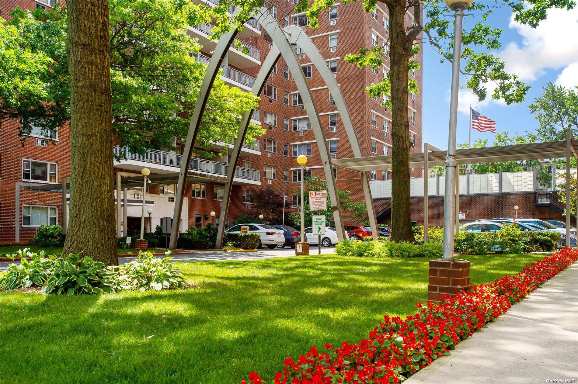 a view of a building with a big yard and large trees