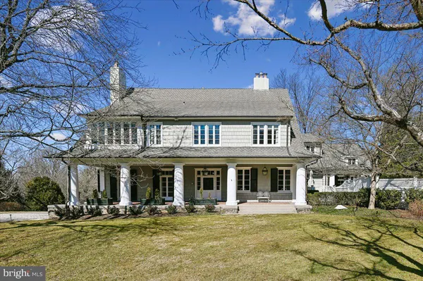 a front view of a building with swimming pool and sitting area