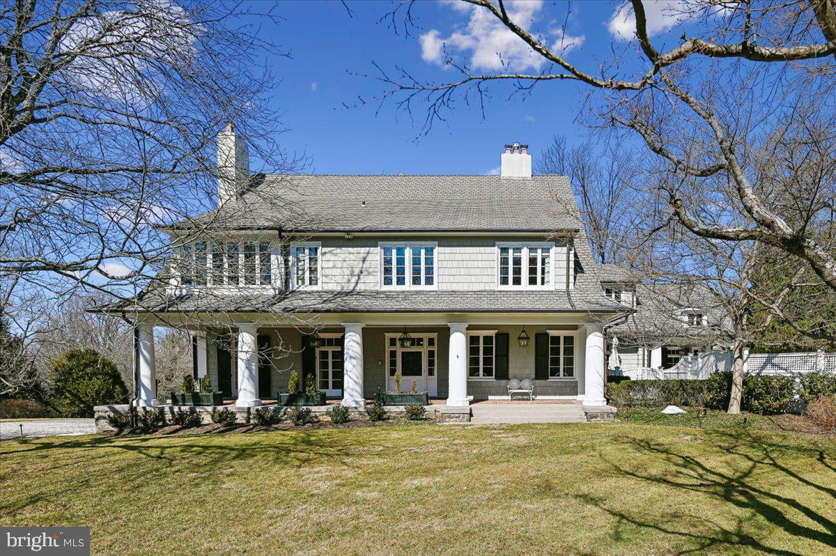 a front view of a building with swimming pool and sitting area