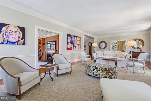 a dining room with furniture a chandelier and wooden floor