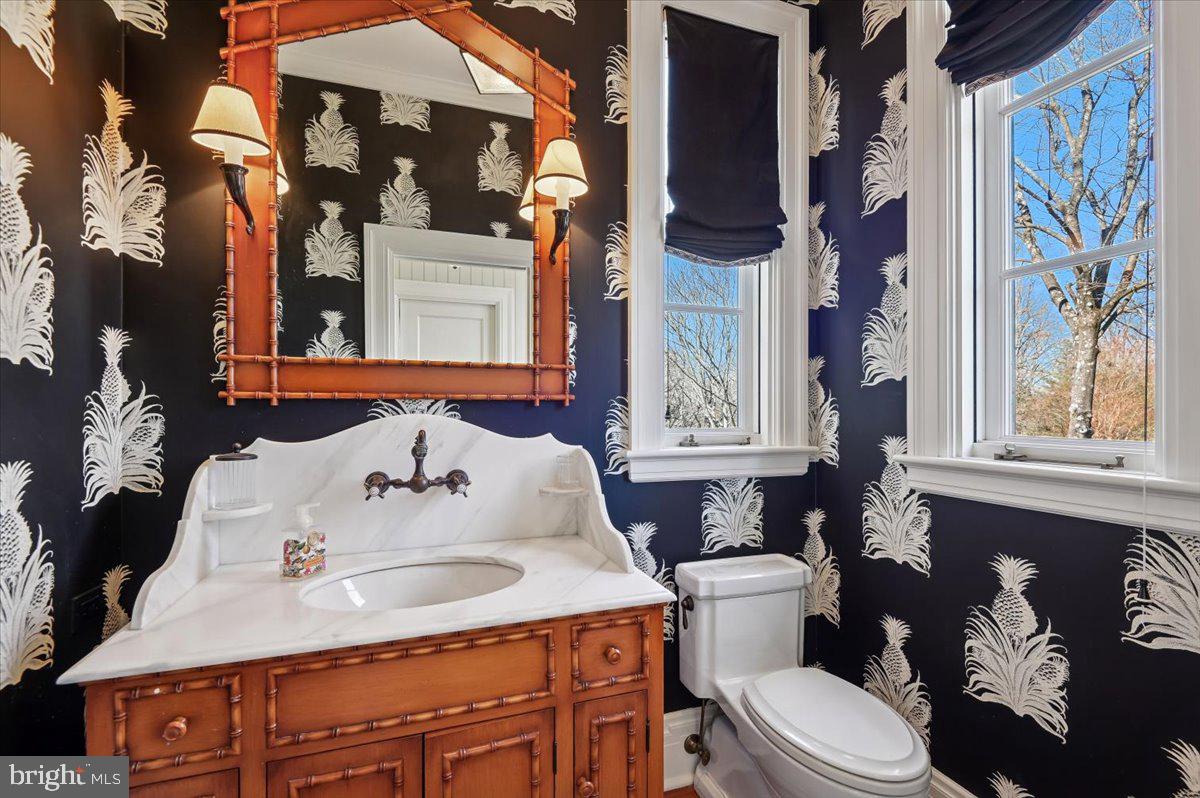 922 Rolandvue Road Baltimore, MD 21204 - Photo 32 of 89 a white toilet sitting next to a bathroom sink