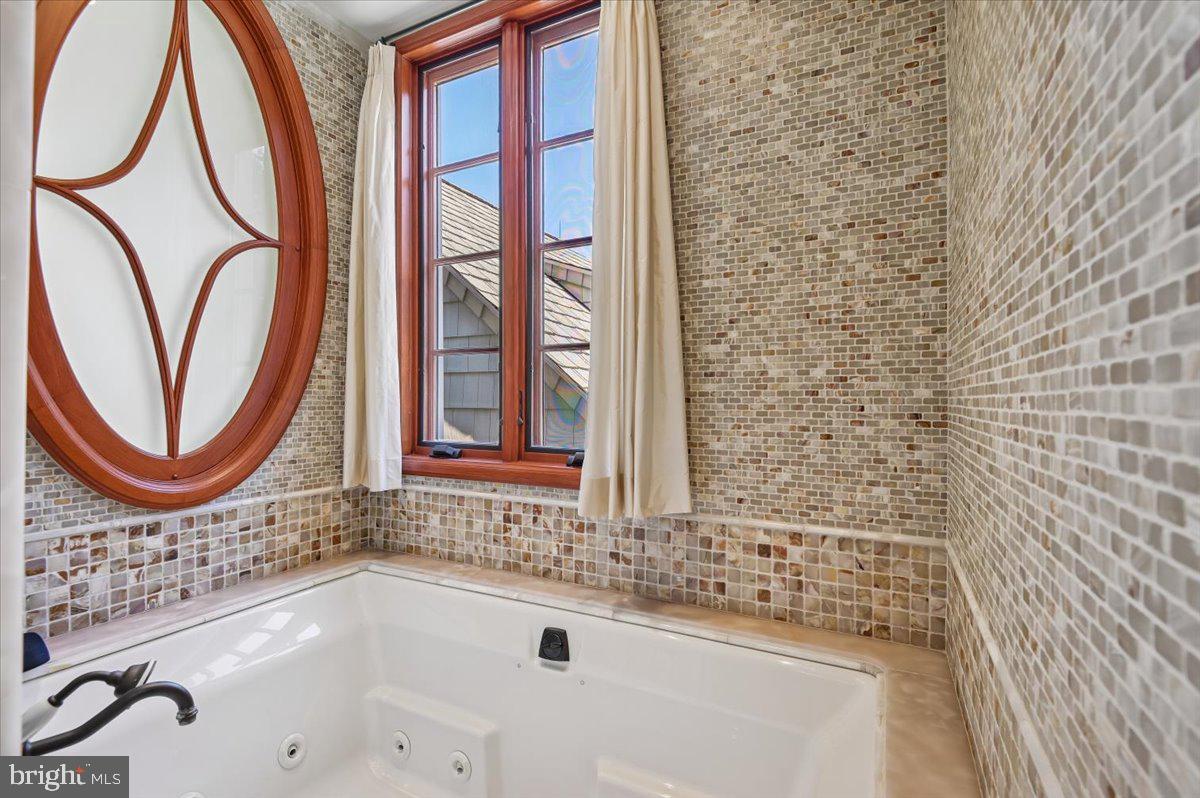 922 Rolandvue Road Baltimore, MD 21204 - Photo 42 of 89 a bathroom with a bathtub a sink and a window