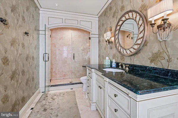 a bathroom with a sink a toilet and a mirror