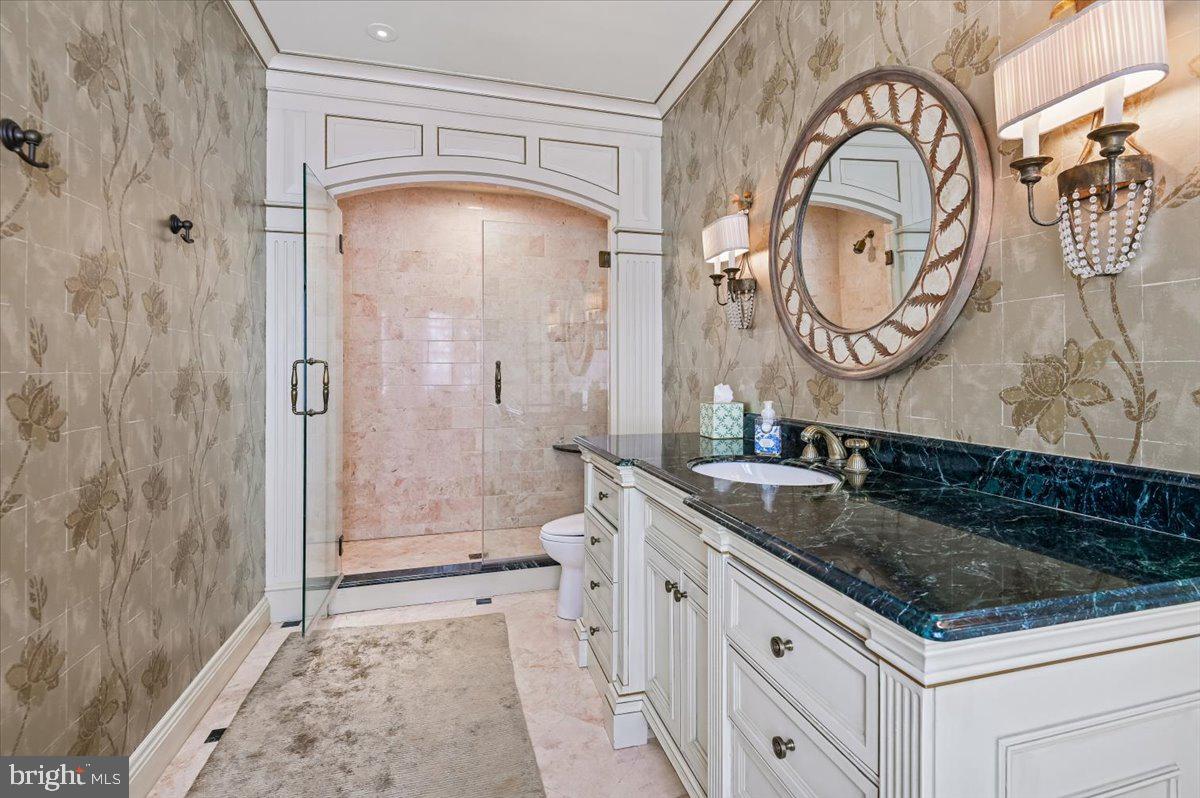 922 Rolandvue Road Baltimore, MD 21204 - Photo 43 of 89 a bathroom with a granite countertop sink a mirror and a shower