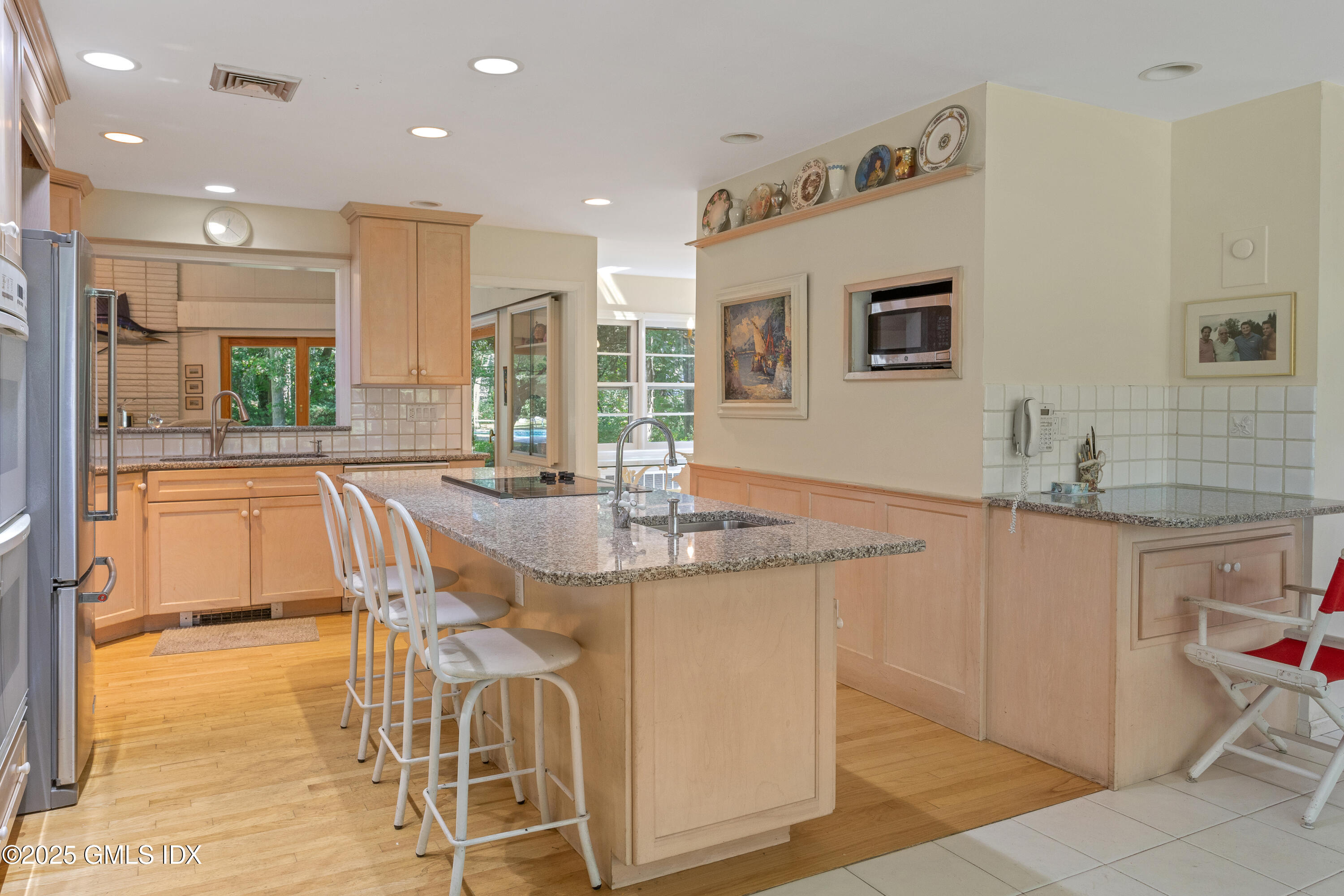 267 Riversville Road Greenwich, CT 06831 - Photo 13 of 23 a kitchen with stainless steel appliances granite countertop a kitchen island a stove a sink a dining table and chairs