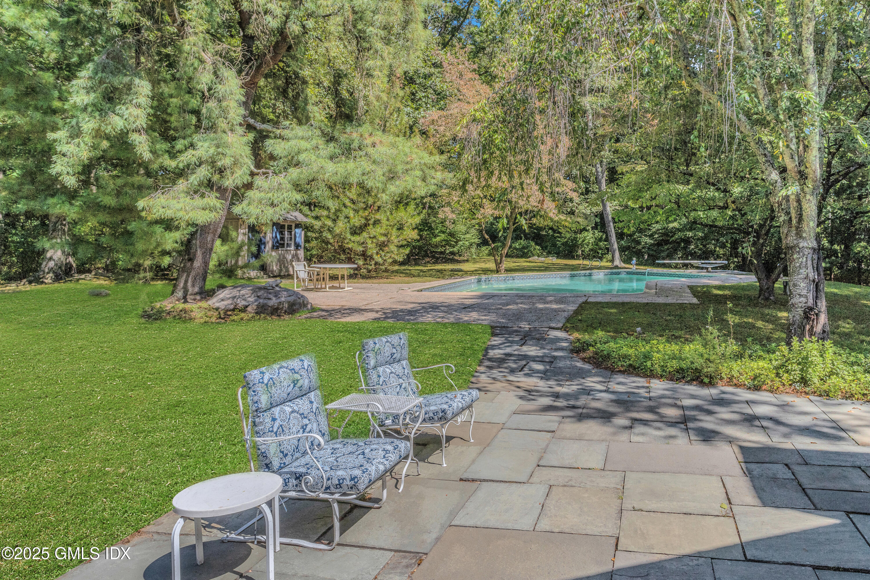 267 Riversville Road Greenwich, CT 06831 - Photo 17 of 23 a view of a garden with plants and large trees