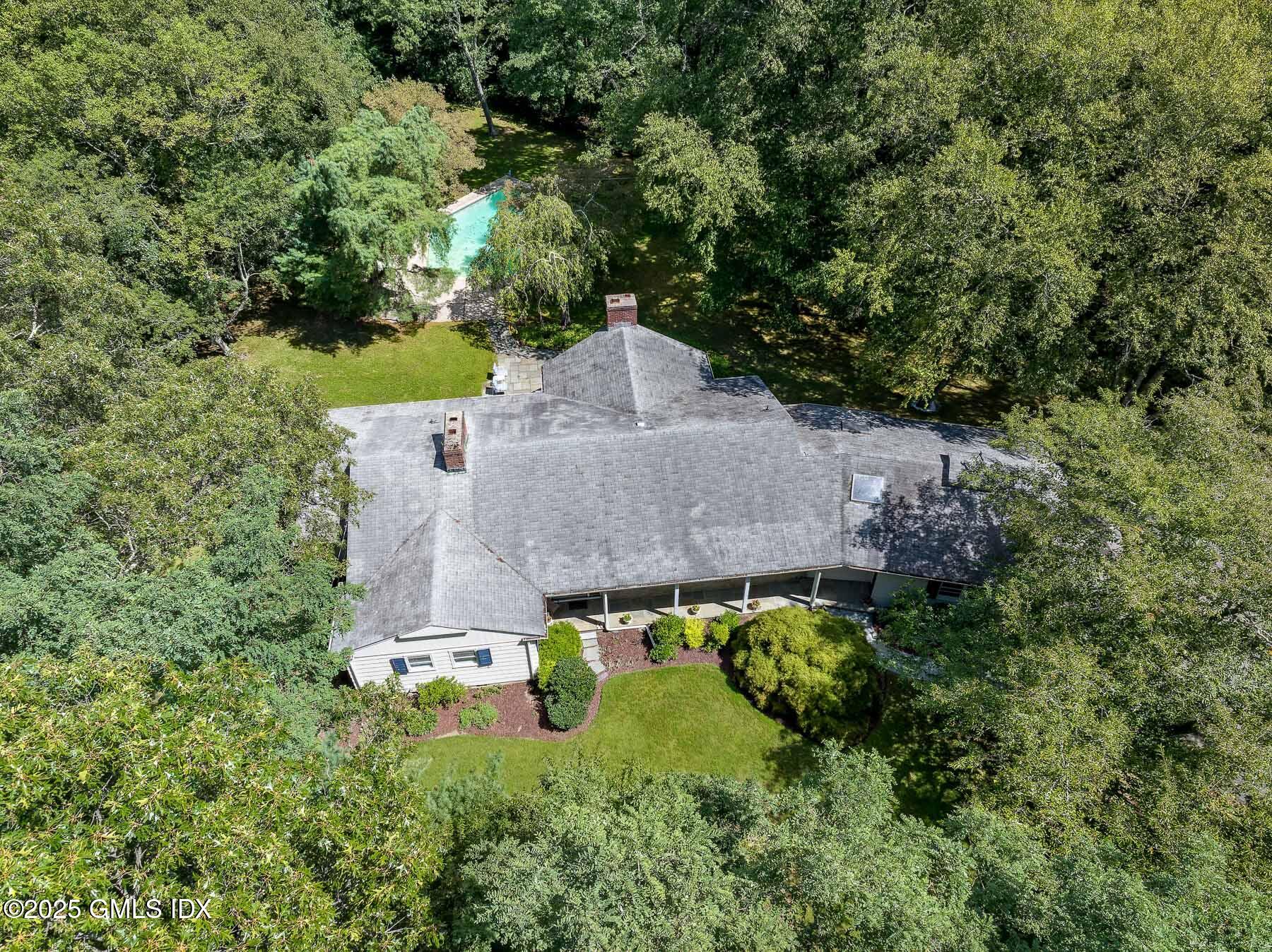 267 Riversville Road Greenwich, CT 06831 - Photo 2 of 23 an aerial view of a house with a yard and large trees