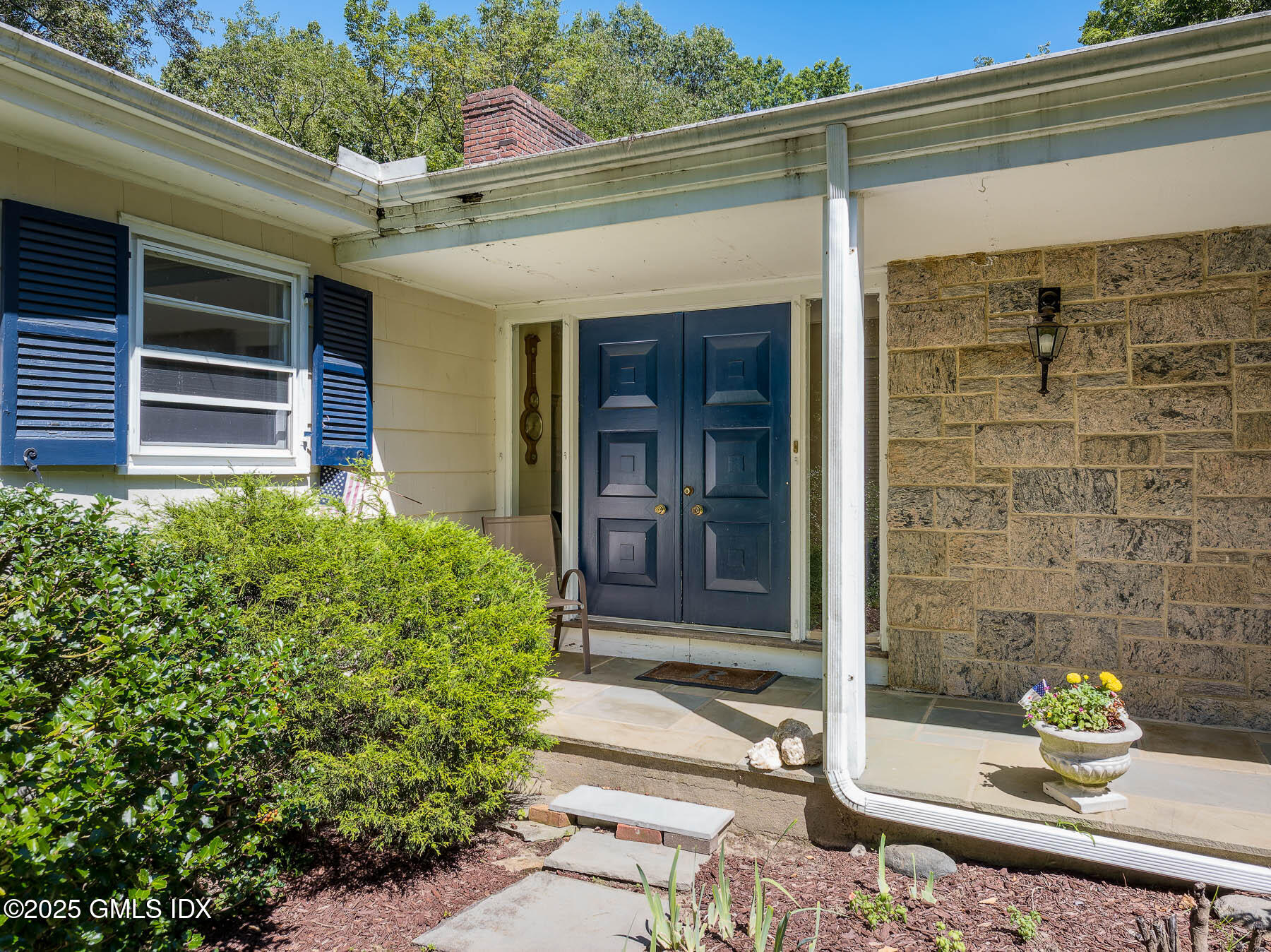 267 Riversville Road Greenwich, CT 06831 - Photo 4 of 23 a front view of a house with a garden