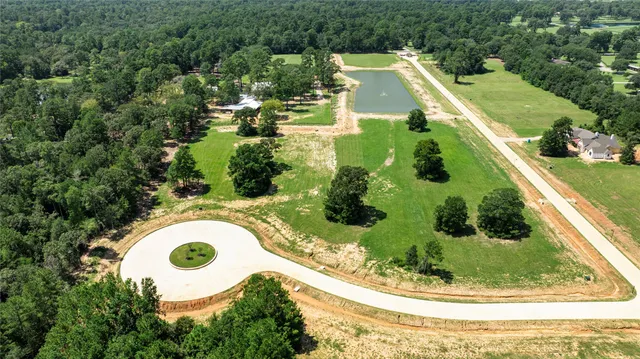 a view of a swimming pool in he middle of the green