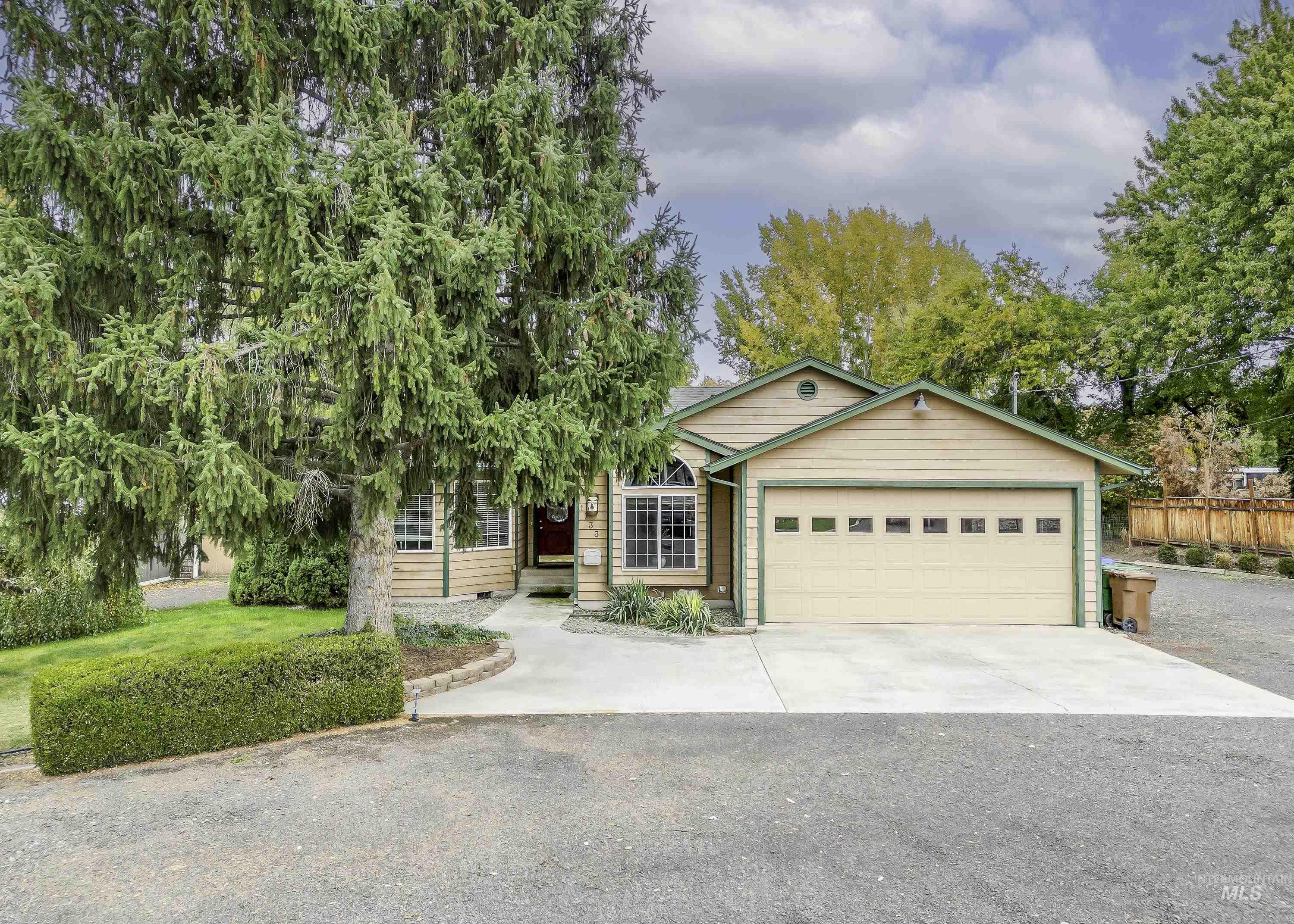 View of front of home featuring concrete driveway and a garage