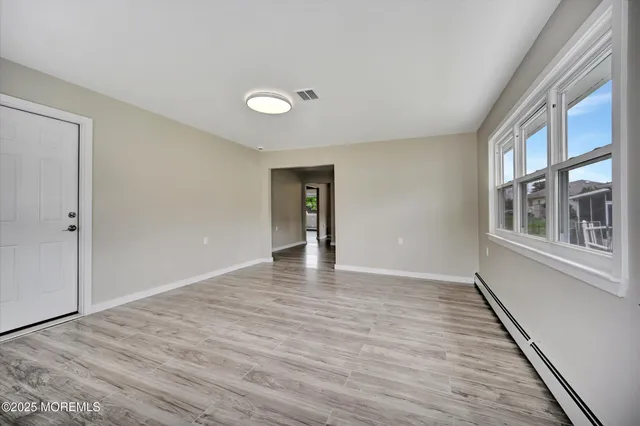 a kitchen with a refrigerator a sink a microwave and cabinets