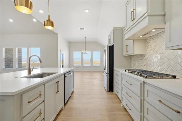 a kitchen with sink stove and cabinets