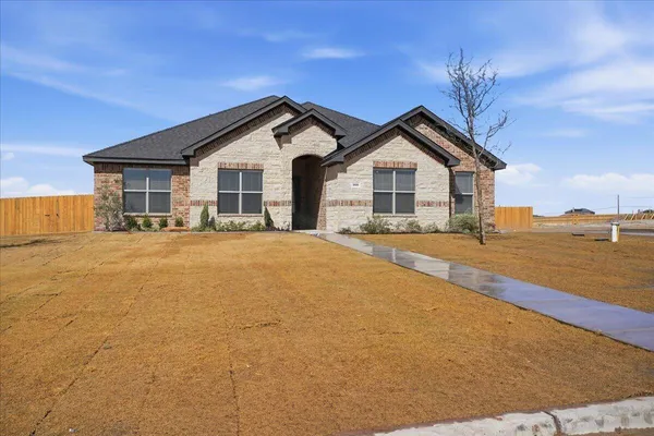 a view of house with a yard