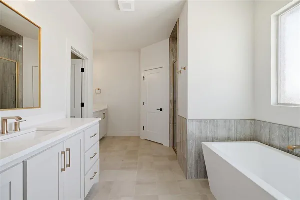 a spacious bathroom with a double vanity sink mirror and