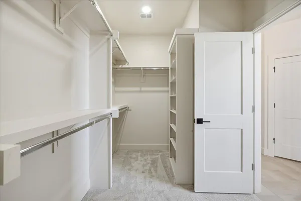 a bathroom with a double vanity sink a large mirror and a bathtub
