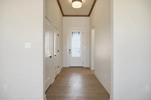 a view of a hallway with wooden floor