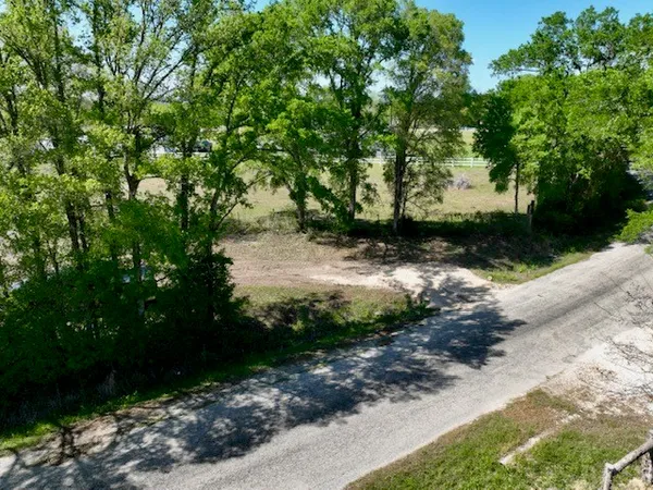 a view of a road with a yard