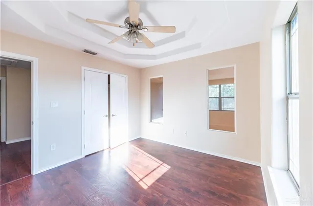 a view of an empty room with wooden floor
