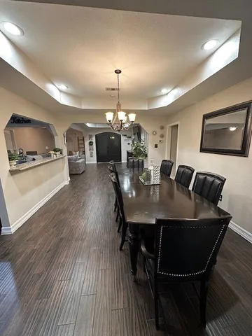 a bedroom with bed and a chandelier