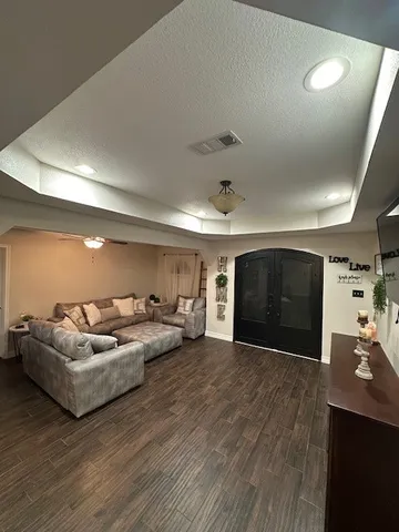 a living room with furniture and a wooden floor