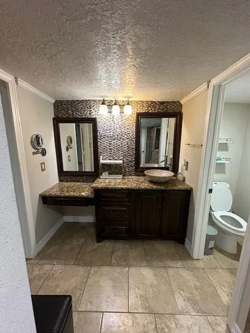 a view of a hallway with wooden floor and furniture
