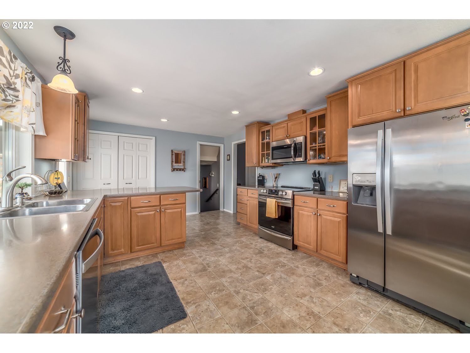 6520 E Street Springfield, OR 97478 - Photo 10 of 32 a kitchen with stainless steel appliances granite countertop a sink refrigerator and cabinets