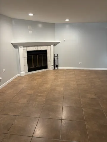 a view of empty room with a fireplace