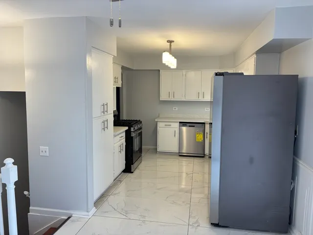 a kitchen with stainless steel appliances a refrigerator and a stove