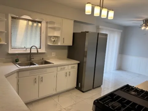a kitchen with stainless steel appliances granite countertop a refrigerator and a sink