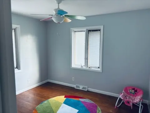 a view of a room with toys and wooden floor