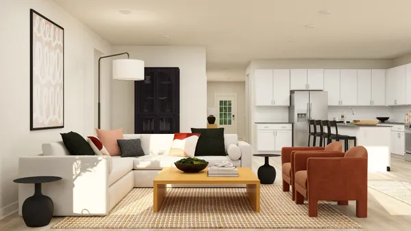 a living room with furniture ceiling fan and a rug