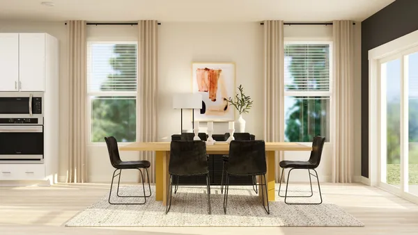 a view of a dining room with furniture and windows