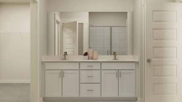 a bathroom with double sink and a mirror