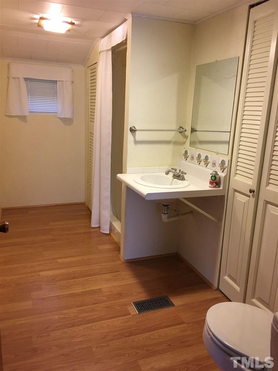 31 Service Road Roxboro, NC 27574 - Photo 12 of 18 a bathroom with a sink and a mirror