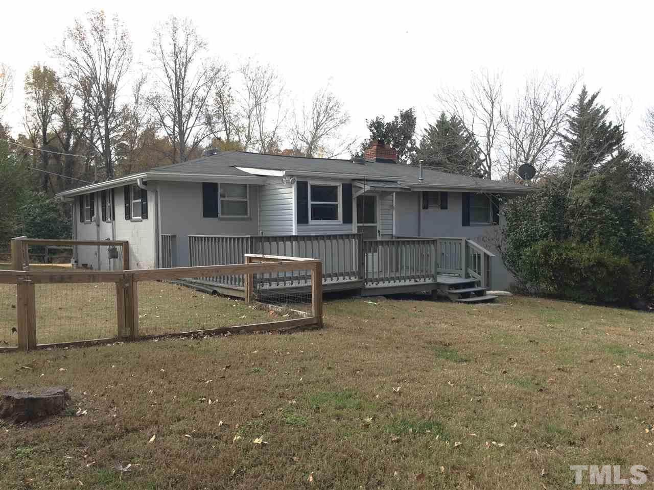 31 Service Road Roxboro, NC 27574 - Photo 3 of 18 a view of a house with a backyard and trees