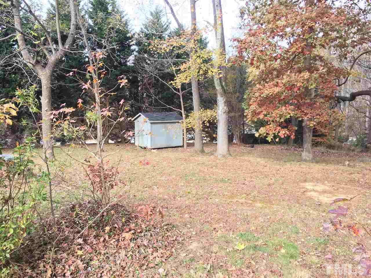 31 Service Road Roxboro, NC 27574 - Photo 5 of 18 a view of house with yard and covered with trees