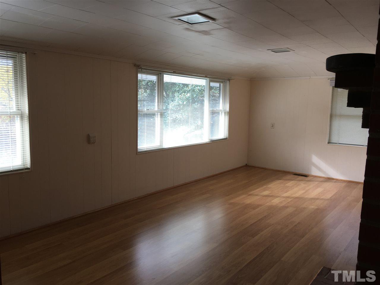 31 Service Road Roxboro, NC 27574 - Photo 7 of 18 a view of an empty room with wooden floor and a window