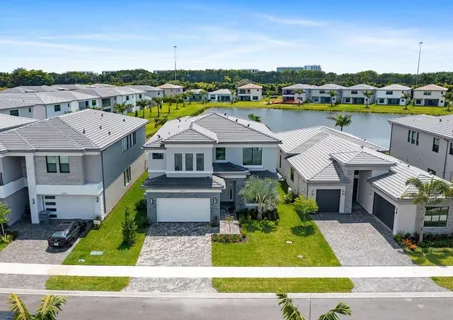 a aerial view of a house with a big yard and potted plants