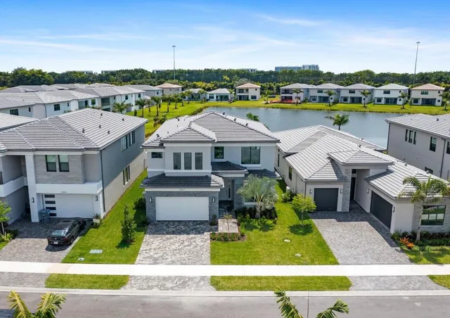 a aerial view of a house with a big yard and potted plants