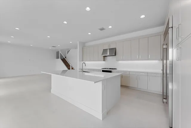 a view of empty room with wooden floor and large window