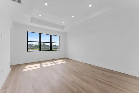 a view of a room with wooden floor