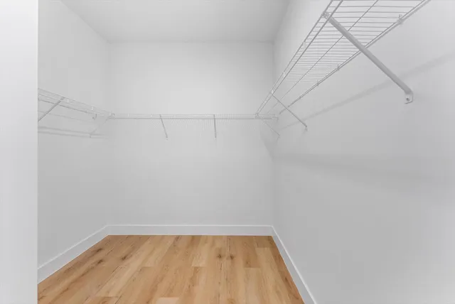 a bathroom with a granite countertop sink toilet and a mirror